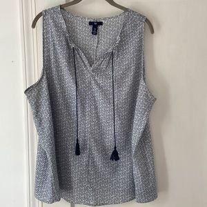 White and navy sleeveless shirt with tie at neck